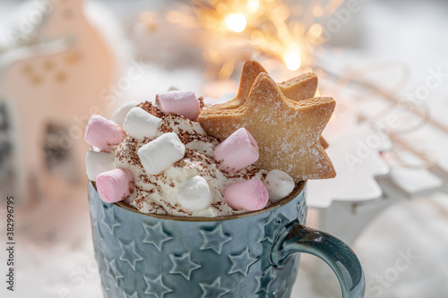 Sweet cocoa with blue scarf for Christmas and sparklers