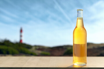 Leinwandbilder - Glass bottle full of yellow liquid standing on wooden plate.
