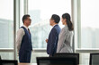 © imtmphoto - asian business men and woman standing and talking in office