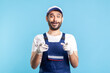© khosrork - Wow hey you! Amazed crazy handyman in overalls pointing to camera and looking surprised. Profession of service industry, courier delivery, housekeeping maintenance. Worker in uniform making choice