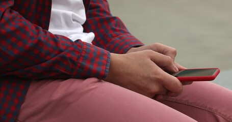 Poster - Close up of a man using mobile smart phone outdoor. Man typing.