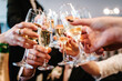 © Serhii - Cheers! People celebrate and raise glasses of wine for toast. Group of man and woman cheering with champagne.