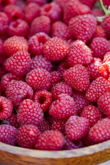 Sticker - raspberries in a wooden bowl in garden