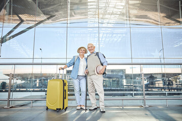 Wall Mural - Pleased aged couple standing near the airport building