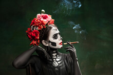 Smoke. Young Girl Like Santa Muerte Saint Death Or Sugar Skull With Bright Make-up. Portrait Isolated On Dark Green Studio Background With Copyspace. Celebrating Halloween Or Day Of The Dead.