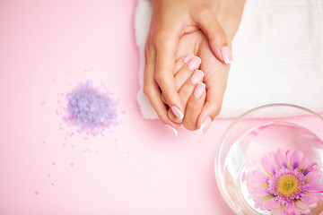 Young woman after getting professional manicure in beauty salon