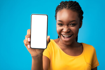 African Woman Showing Phone Blank Screen On Blue Background