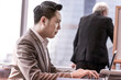 © lukyeee_nuttawut - businessman talking online meeting conference during meeting business deal at skyscraper office lounge with cityscape business zone background