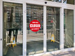 © scaliger - Office building closed due to COVID-19, sign with sorry in street door