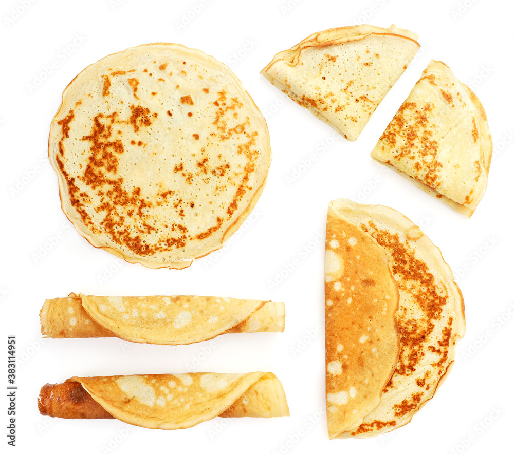 Set of thin pancakes on a white background, isolated. Top view - obrazy, fototapety, plakaty 