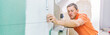 © karepa - middle aged male worker installing large format tiles on wall