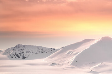 Wall Mural - snow-covered mountains of svalbard at dusk