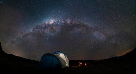 Wall Mural - an amazing night sky at atacama desert. a tent, a campfire and the milky way over us, just an awe ni