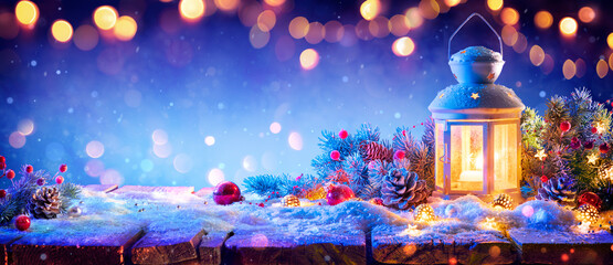 Wall Mural - decorative christmas lantern with ornament and fir branches and defocused lights