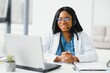 © Serhii - African American doctor working in her office at clinic