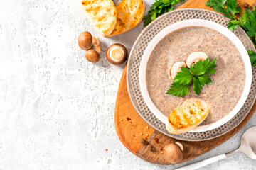 Sticker - Mushroom cream soup. Champignon soup puree, toast and parsley on a gray concrete background top view. Free space for text. Tasty winter food, vegetarian food. Copy space.