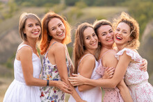 A Cheerful Company Of Beautiful Girls Friends Enjoy The Company And Have Fun Together In A Picturesque Place Of Green Hills.