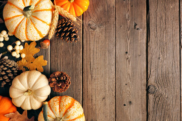 Aufkleber - Natural fall side border of pumpkins and leaves. Top view on a rustic dark wood background with copy space.