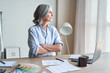 © insta_photos - Stylish elegant mature business woman fashion designer thinking on new creative ideas at workplace standing with arms crossed looking through window. Classy middle aged older lady dreaming in atelier.