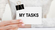 © Veranika - The girl holds a sheet for notes with the text MY TASKS.
