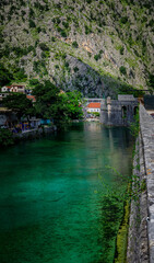 Poster - Emerald green waters of Kotor Bay or Boka Kotorska and the ancient wall of Kotor former Venetian fortress in Montenegro