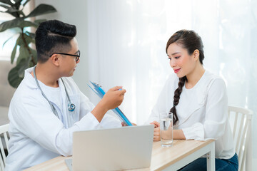 Wall Mural - Healthcare concept of Obstetrician-gynecologist doctor consult with young woman about her health in clinic or hospital.