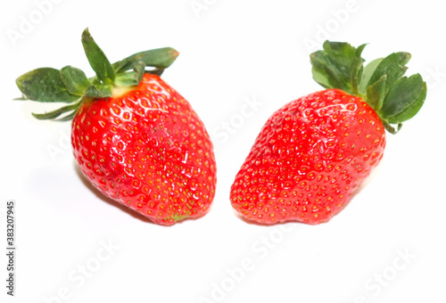Juicy red strawberries on a white background © Oleg