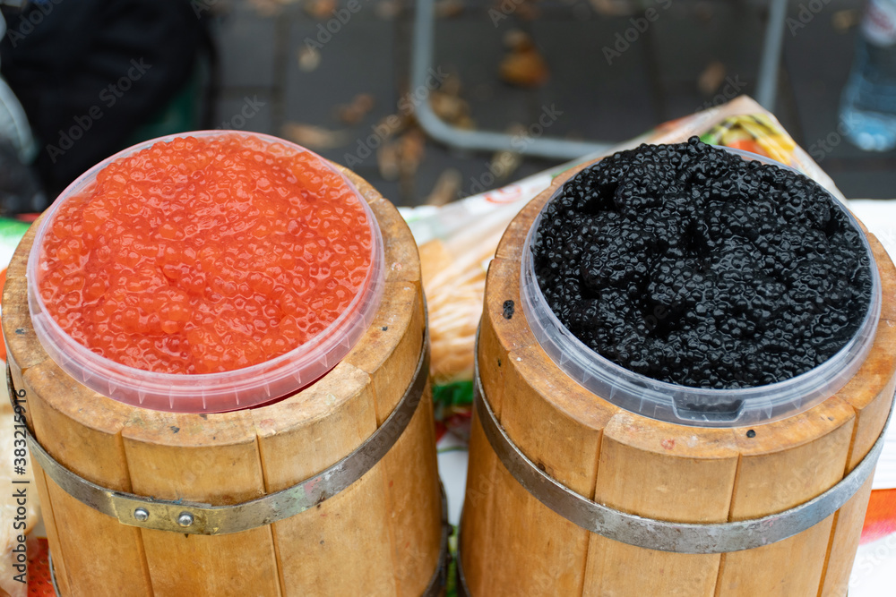 Salmon Roe Vs Sturgeon Roe Salmon roe and sturgeon red and black caviar served in a wooden barrel ...