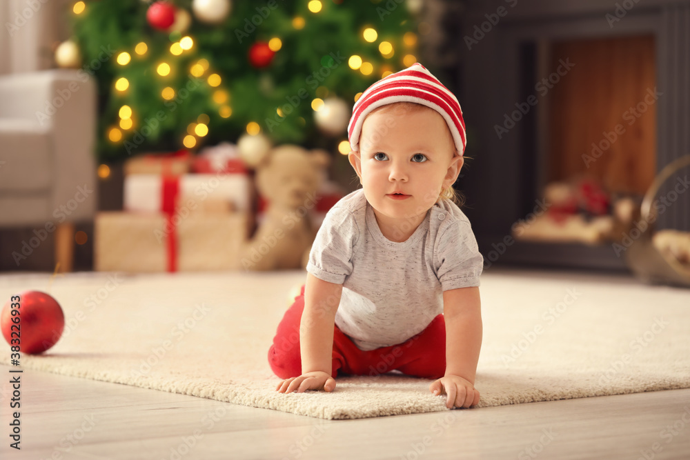 Cute little baby in room decorated for Christmas