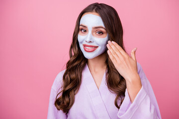 Sticker - Photo portrait of beautiful girl doing facial spa procedures applying nourishing mask smiling isolated on pink color background