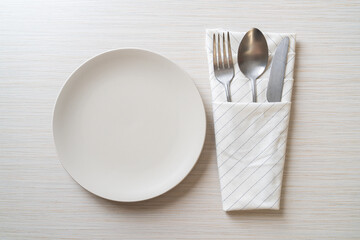 Wall Mural - empty plate or dish with knife, fork and spoon