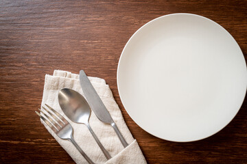 Wall Mural - empty plate or dish with knife, fork and spoon