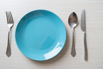 Wall Mural - empty plate or dish with knife, fork and spoon