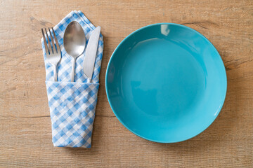 Wall Mural - empty plate or dish with knife, fork and spoon