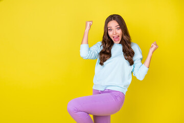 Poster - Photo of pretty lovely crazy young girl raise fists knee ecstatic pose open mouth win cinema tickets quiz wear blue sweater violet trousers isolated bright yellow color background