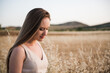  Beautiful young Caucasian woman with long blond hair and sensual appearance against a background of a wheat field. selective focus portrait girl pensive