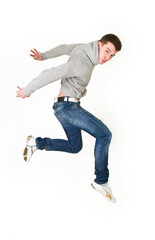 Young man dancing in a gray sweatshirt on a white background