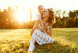© JenkoAtaman - Happy family: mother and son hugging in nature in summer