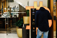 Bald Man Uses Bitcoin ATM Machine In Mall For Cryptocurrency Exchange