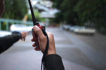 Security guard uses radio communication for facilitate traffic. Traffic Officers use walkie talkie to maintain order in the parking lot in Thailand.