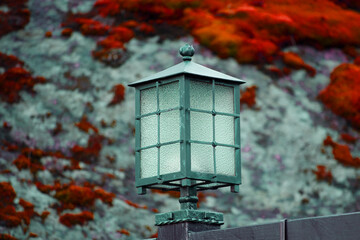 Sticker - street lamp on a background of autumn leaves