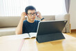 © zasabe - Asian man aged 30-40 years using tablet, watching lesson online course communicate by conference video call from home, e-learning education concept