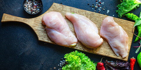 fresh chicken breast raw meat on the cutting board table top view copy space for text keto or paleo diet food background rustic