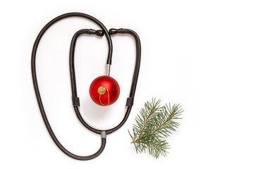 Medical Christmas card with a stethoscope and a spruce branch on a white background. new year's medicine. Copy space. Flat lay.