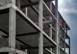 Reinforced concrete construction, load-bearing structure on cloudy sky background
