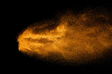 Wall Mural - abstract orange powder explosion isolated on black background.
