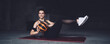 © BullRun - Strong woman doing sit ups with ball