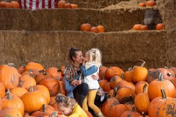 Happy young family at the pumpkin farm