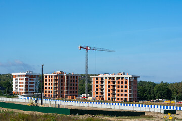 Construction site with a tower crane. Construction of multi-storey residential buildings