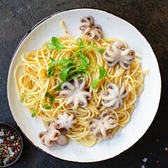 pasta spaghetti baby octopus seafood warm fresh salad second course on the table serving size top view copy space for text food background rustic